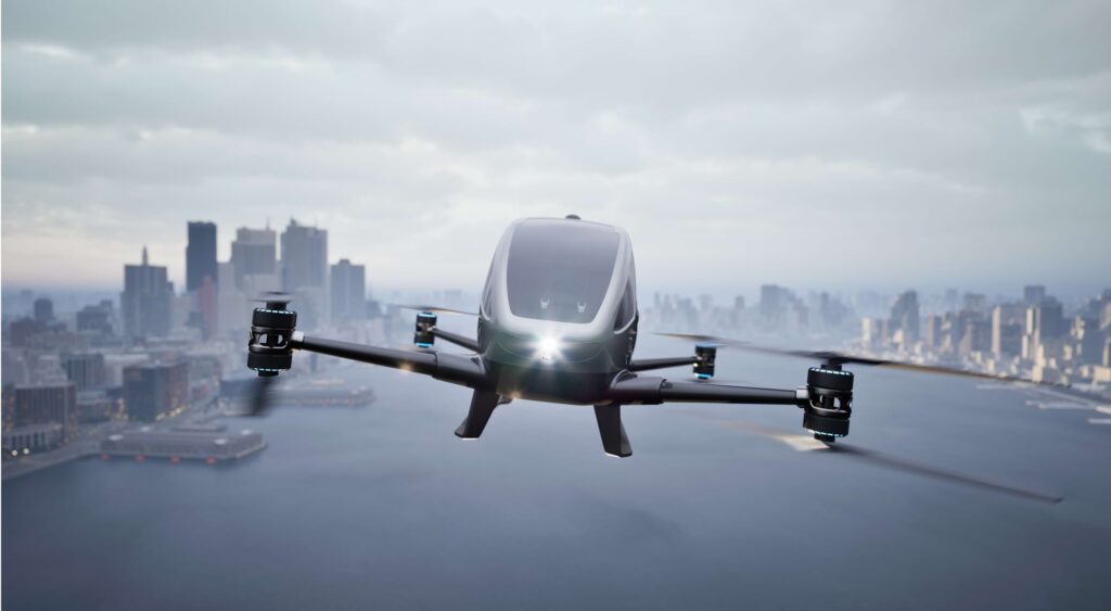 a futuristic flying vehicle flying over a city.